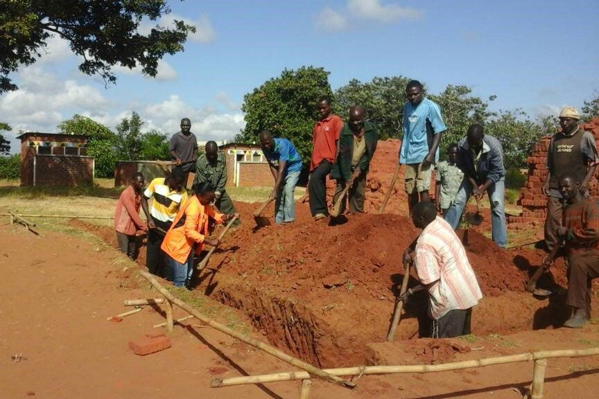 Community members digging a classroom block foundation at Masangano primary school in Ntchisi