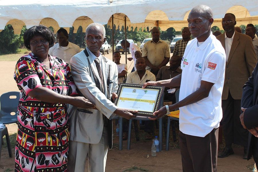 Traditional Authority Makhuwira receiving the ODF Certificate from Mr. Beston Chisamile